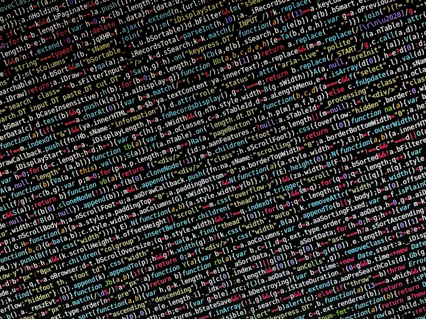 A photograph of a computer screen displaying complex lines of computer code in various colors, including red, yellow, green, blue, and white, on a black background. The code contains multiple function